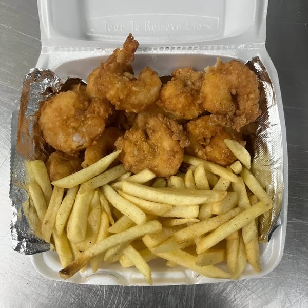Dat Bayou Spot's fried shrimp and french fries in a white takeout container.