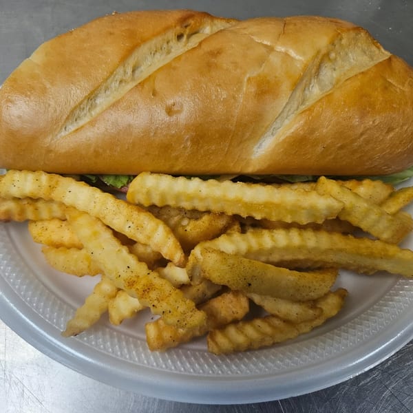 A Dat Bayou Spot po'boy sandwich with crispy crinkle-cut fries on a white plate.